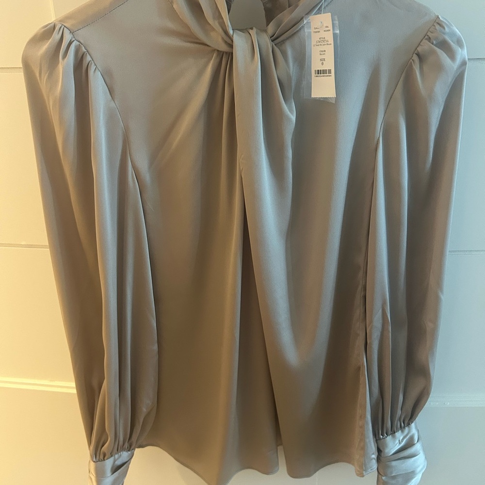 This satin blouse has a twisted neckline keyholes and blouson sleeves for flair - Picture 7 of 7